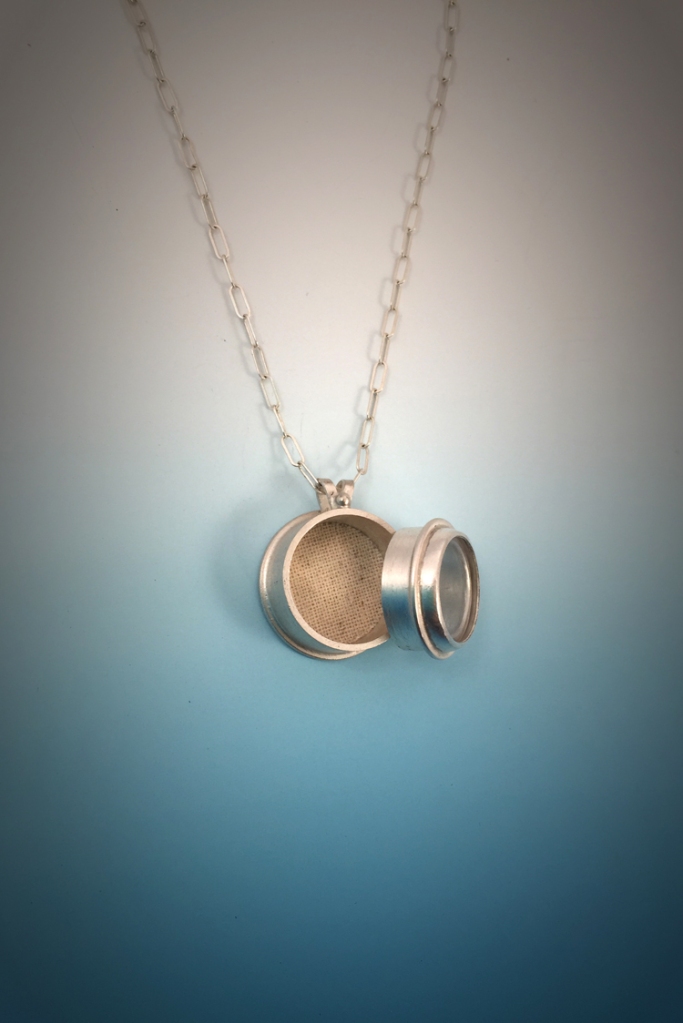 This necklace was made for a client whose mother recently passed away. The pendant is a locket that holds the ashes of her mother. 
